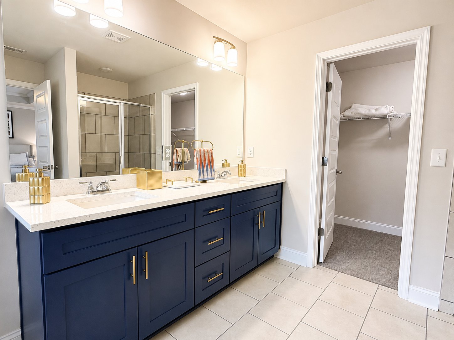 Enclave — bathroom with navy vanity and brass hardware