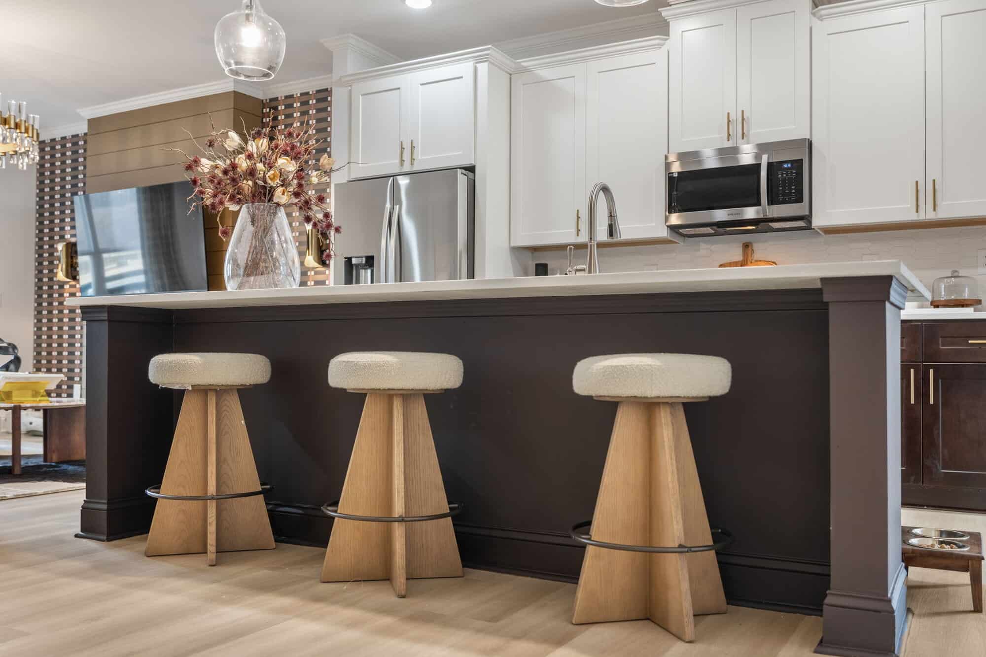 Porter Reserve — kitchen with dark island and white uppers